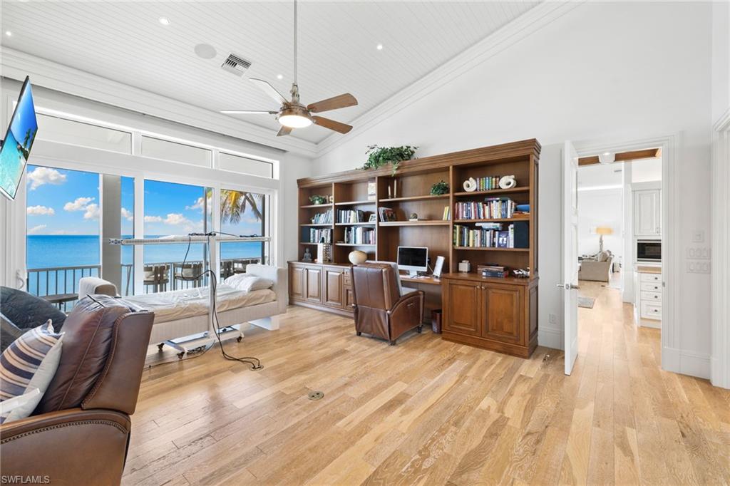 Home office featuring high vaulted ceiling, light wood-style floors, a ceiling fan, recessed lighting, and ornamental molding