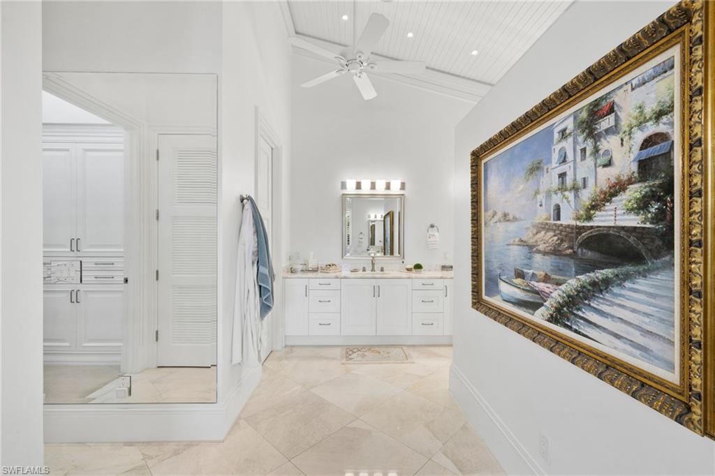 Full bathroom featuring vanity, a ceiling fan, a towering ceiling, and recessed lighting