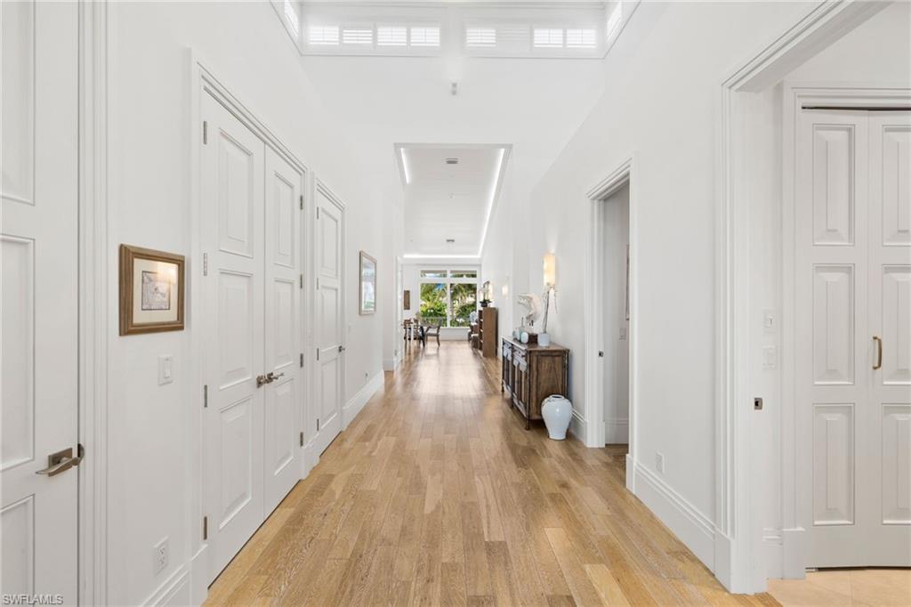 Corridor with light wood-style floors and baseboards