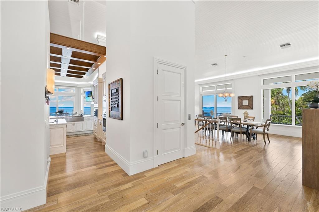 Corridor featuring light wood-style flooring and beam ceiling