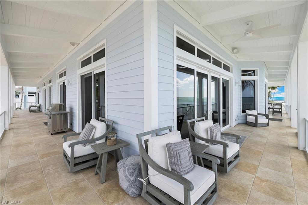 View of patio featuring grilling area, french doors, and a ceiling fan