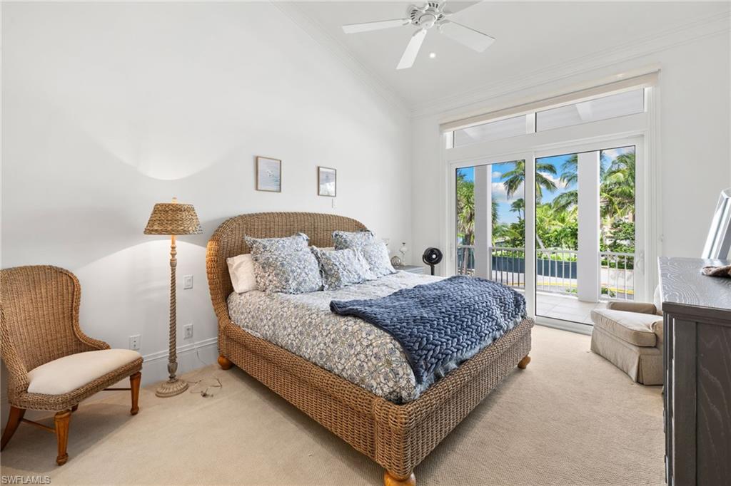 Carpeted bedroom featuring high vaulted ceiling, access to outside, ceiling fan, and ornamental molding