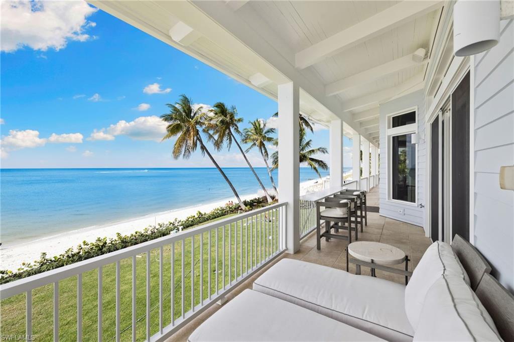 Balcony with view of water and beach