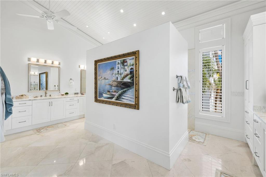 Bathroom featuring vanity, recessed lighting, ceiling fan, wooden ceiling, and a towering ceiling