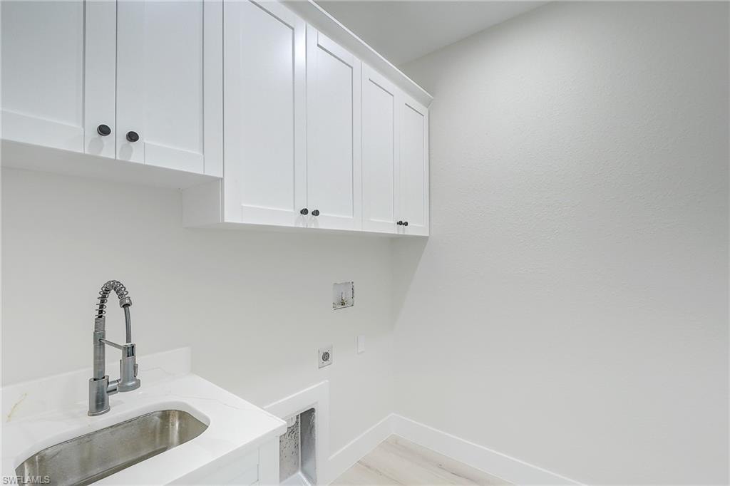 Bathroom featuring a textured wall, vanity, and a stall shower