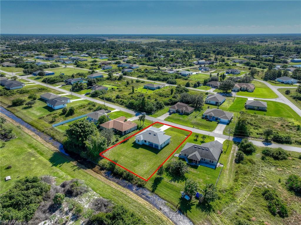 Aerial view of residential area featuring property boundaries highlighted