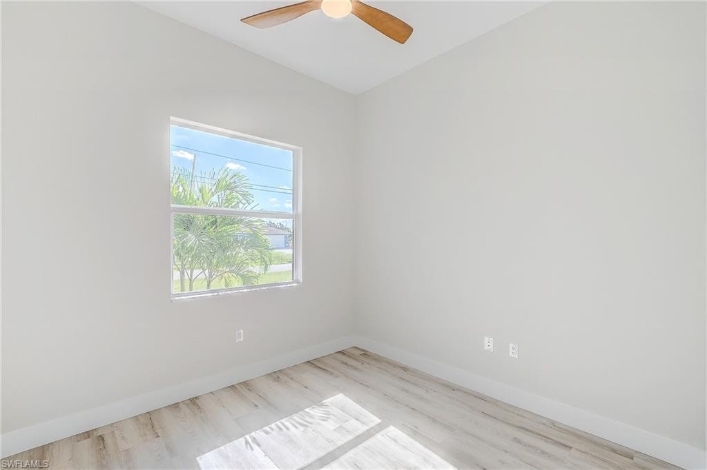 Office with light wood-style floors and ceiling fan
