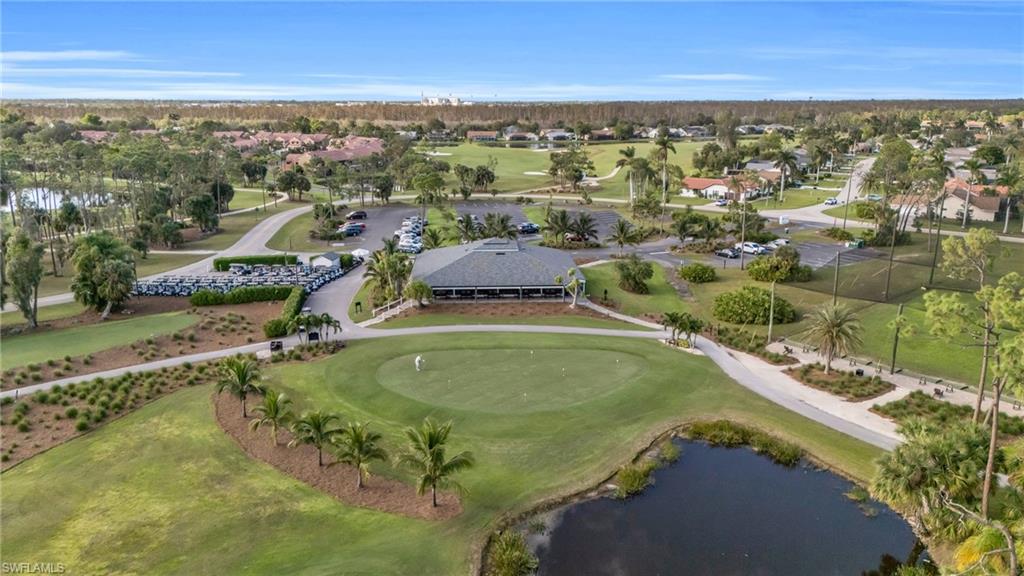 Aerial view featuring a water view and golf course view