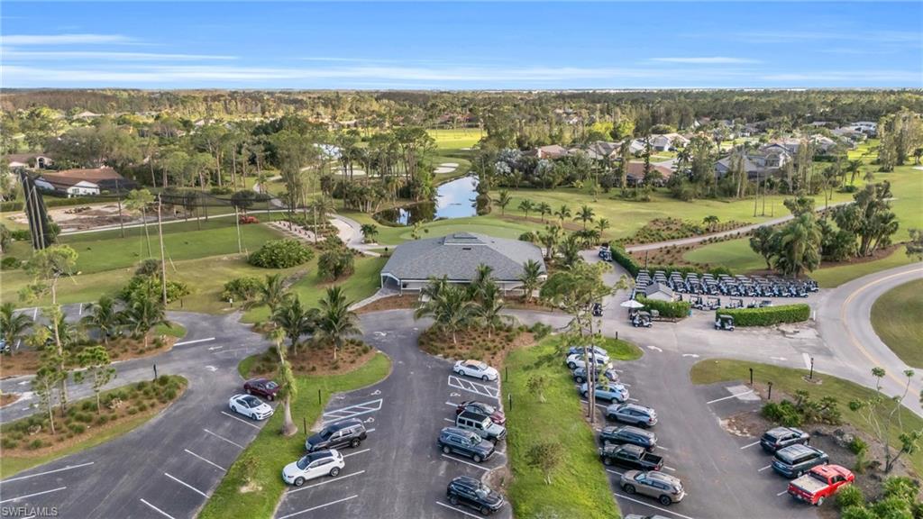 Aerial view featuring a water view and view of golf course