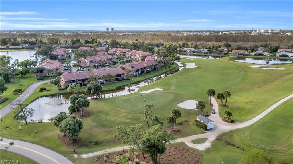Bird's eye view with view of golf course and a water view