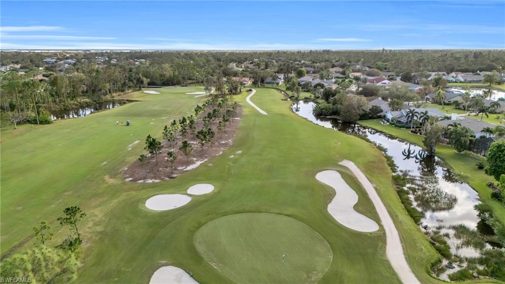 Drone / aerial view featuring a residential view, view of golf course, and a water view