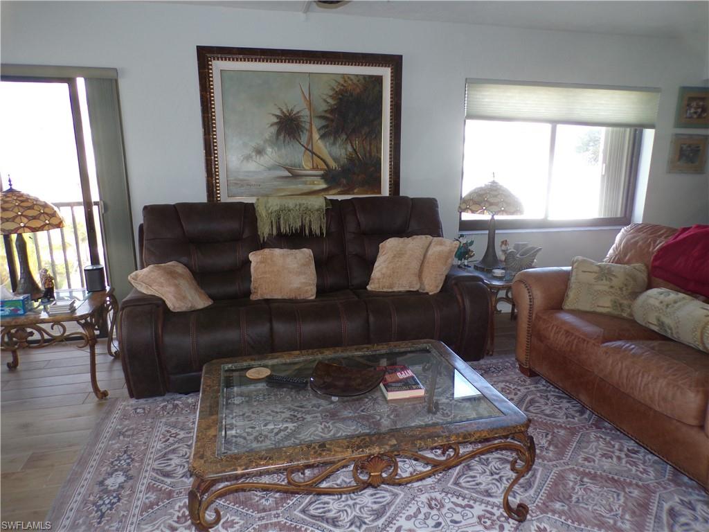 Living room featuring wood finished floors and ceiling fan