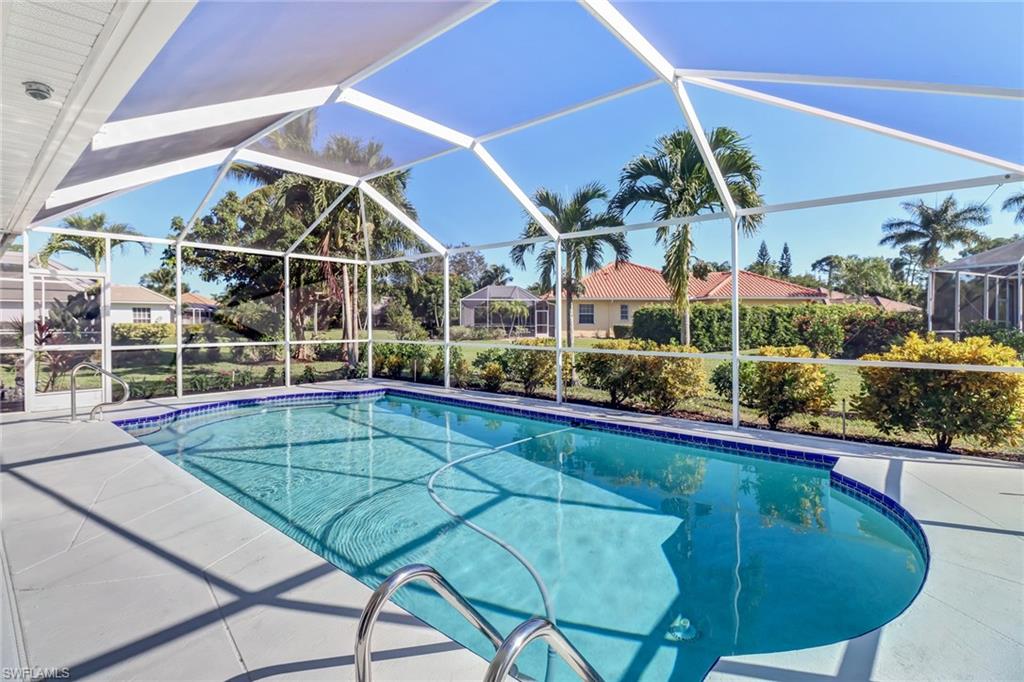 Swimming pool with a sunroom, a lanai, and a patio area