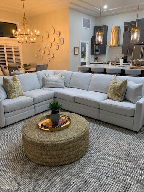 Living area with a chandelier and recessed lighting