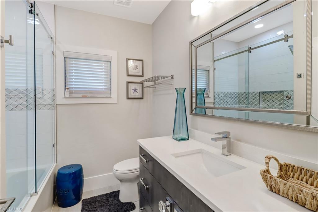 Full bath with vanity and enclosed tub / shower combo