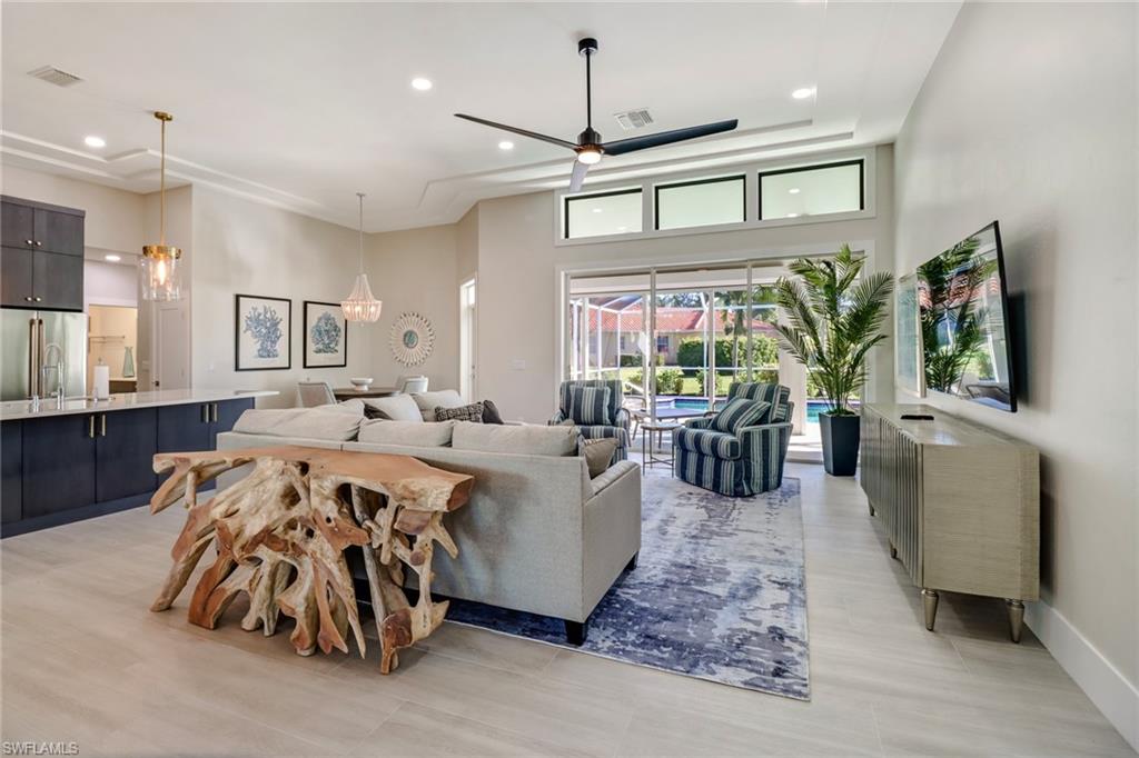 Living area featuring recessed lighting, a ceiling fan, and a high ceiling