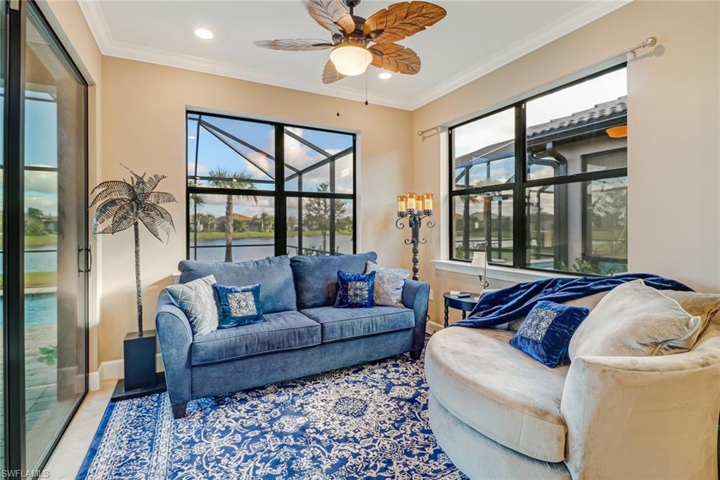 Tiled living area with crown molding, a sunroom, a water view, plenty of natural light, and recessed lighting