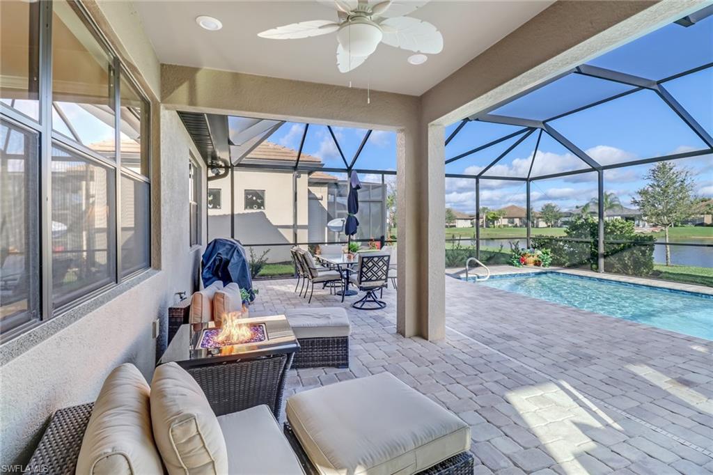 Swimming pool with a water view, a patio, a lanai, and a sunroom