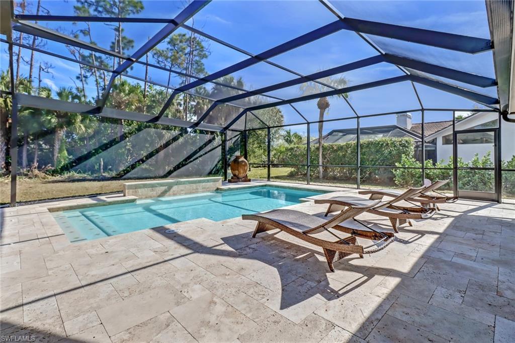 Swimming pool featuring a lanai, a sunroom, and a patio area