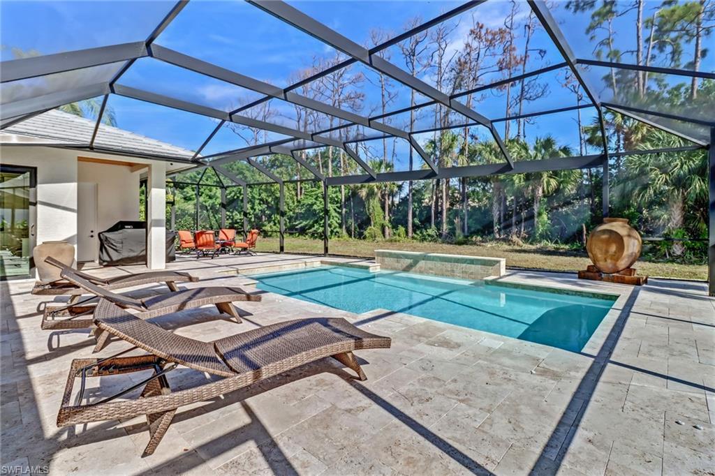 Swimming pool with a patio area, a lanai, a sunroom, and a jacuzzi