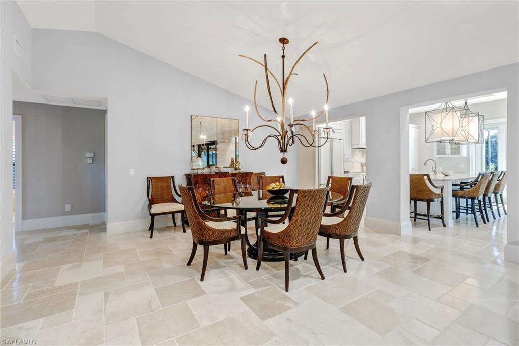 Dining area with vaulted ceiling and a chandelier