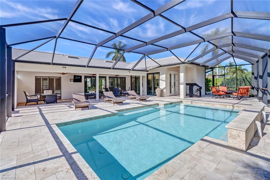 Outdoor pool featuring a sunroom, a patio area, ceiling fan, and outdoor lounge area
