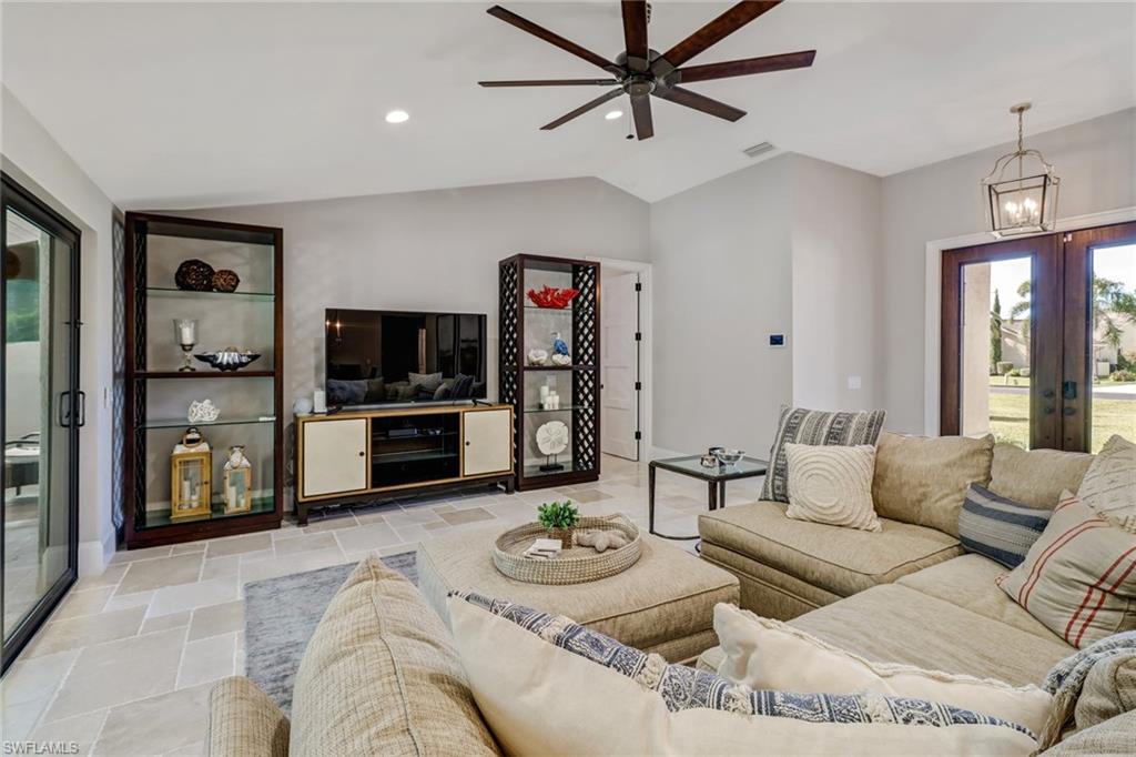Living area featuring plenty of natural light, vaulted ceiling, recessed lighting, french doors, and ceiling fan