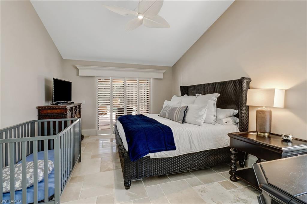Bedroom featuring ceiling fan and high vaulted ceiling