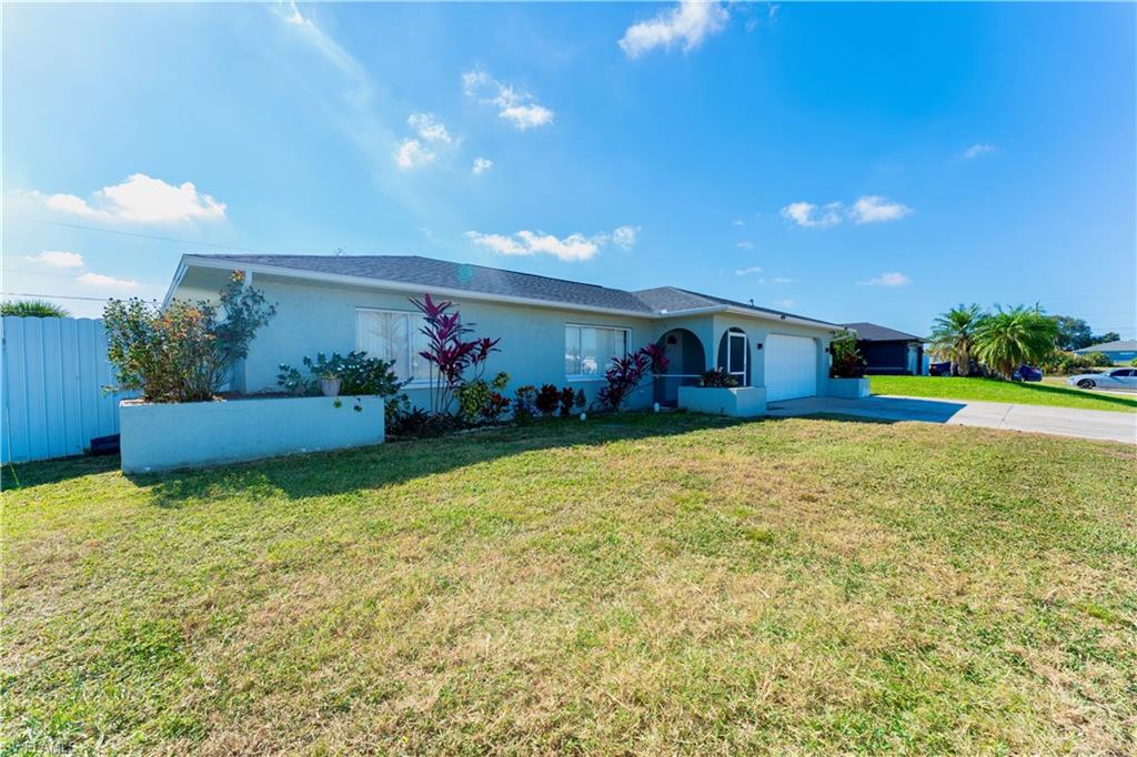 Single story home featuring stucco siding, driveway, and an attached garage