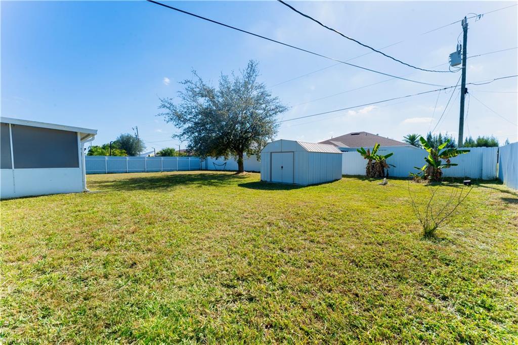Fenced backyard with a storage shed