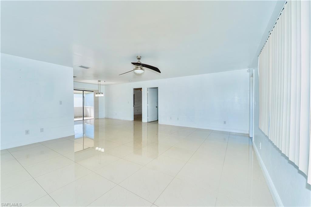 Spare room with a ceiling fan and light tile patterned floors