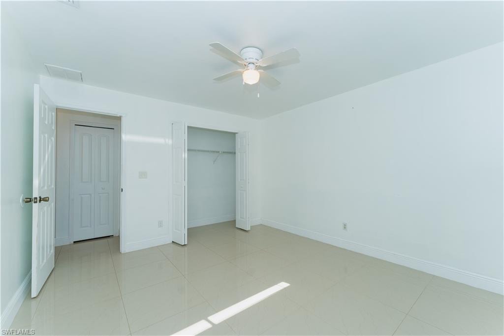 Unfurnished bedroom with a closet and a ceiling fan
