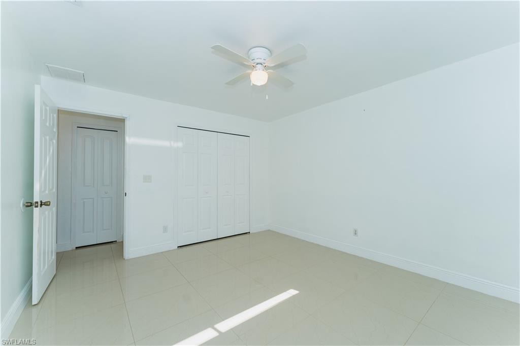 Unfurnished bedroom featuring a closet and ceiling fan