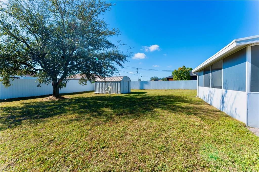 Fenced backyard with a storage shed
