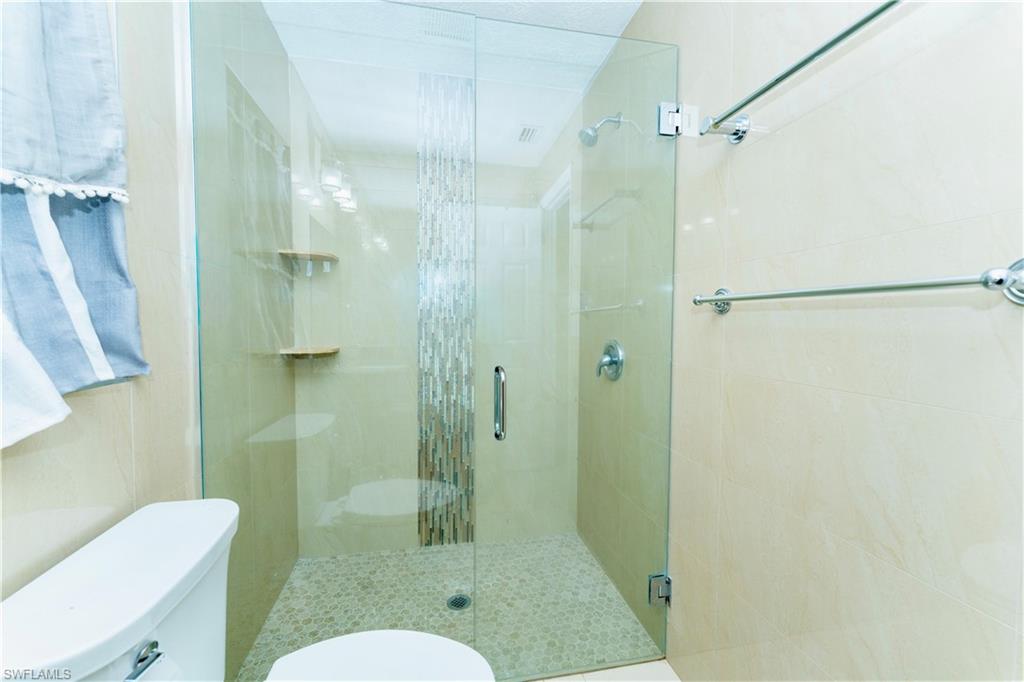 Full bathroom featuring a stall shower
