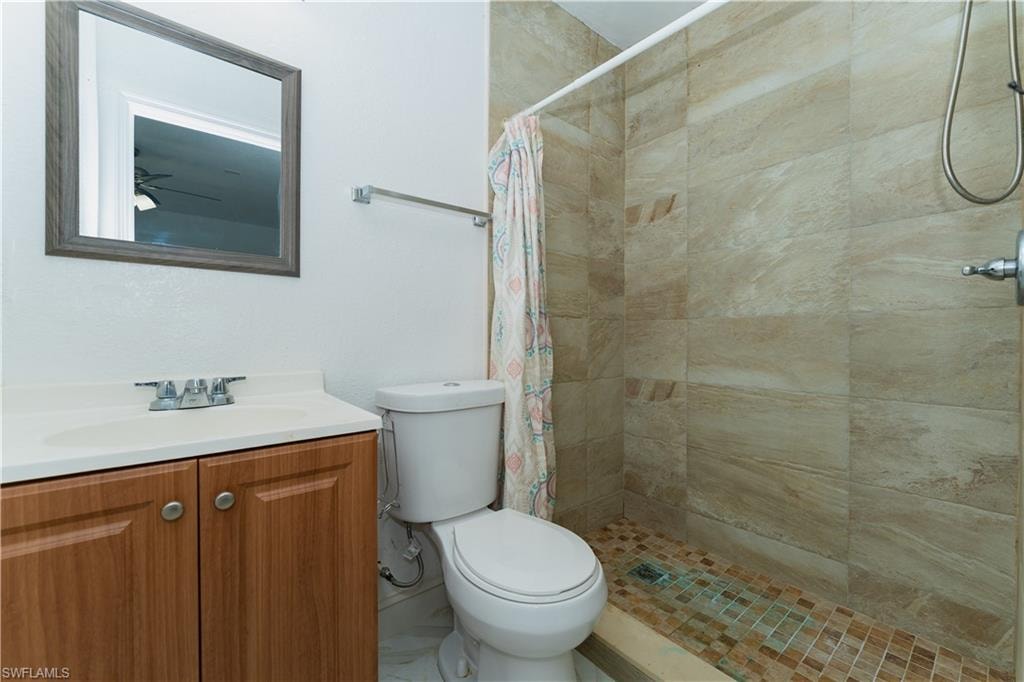 Bathroom featuring a stall shower and vanity