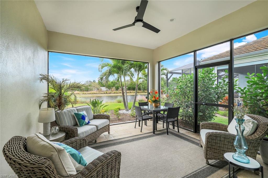 Sunroom with a water view and ceiling fan