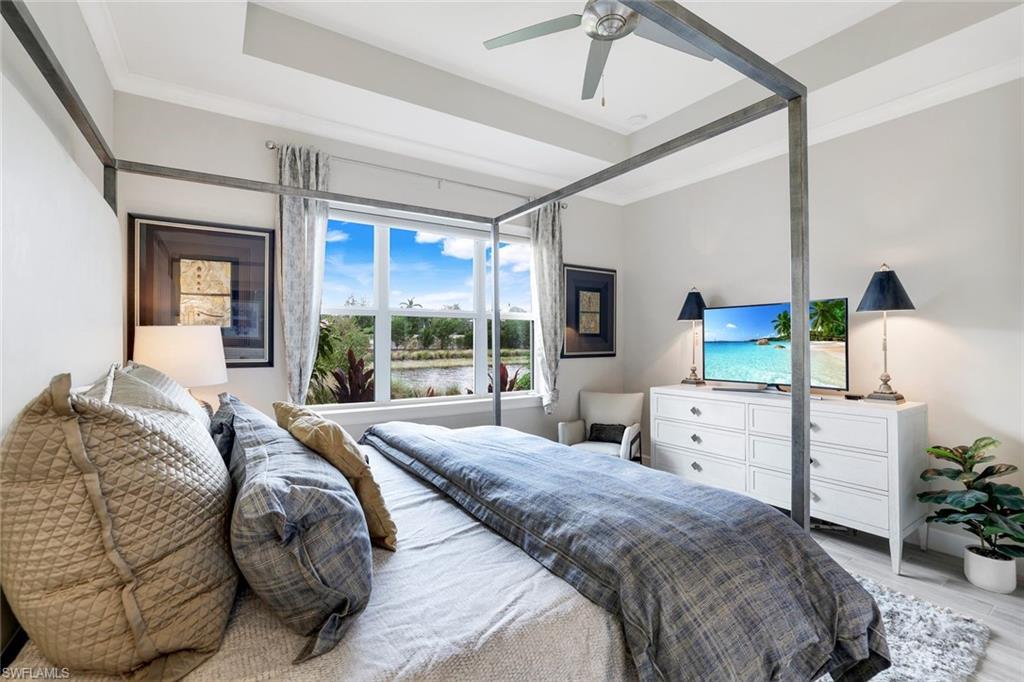 Bedroom with light hardwood / wood-style flooring, ceiling fan, and ornamental molding