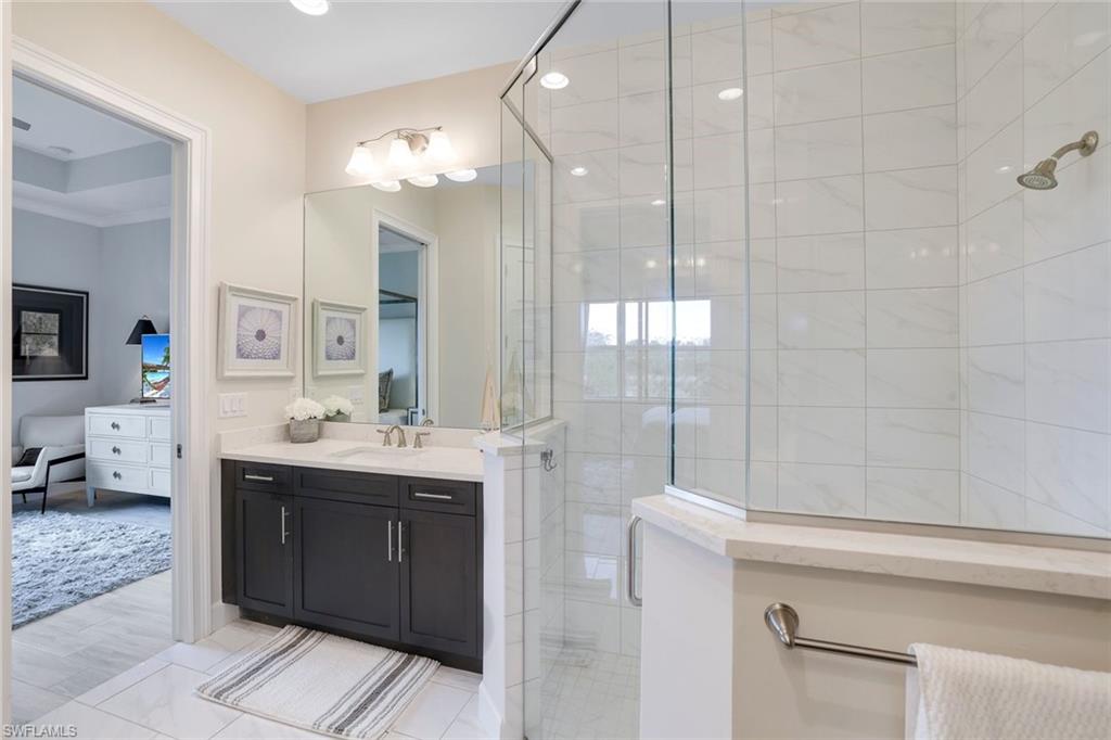 Bathroom with hardwood / wood-style floors, vanity, and a shower with door