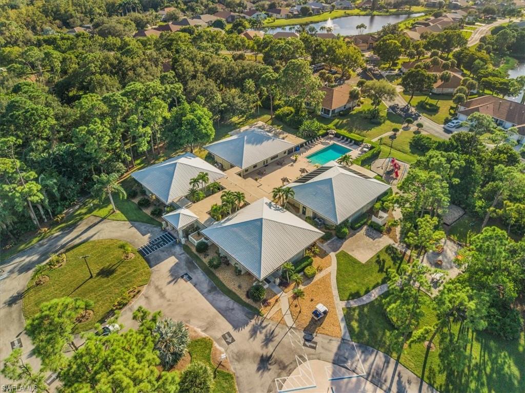 Drone / aerial view of a nearby body of water and a pool