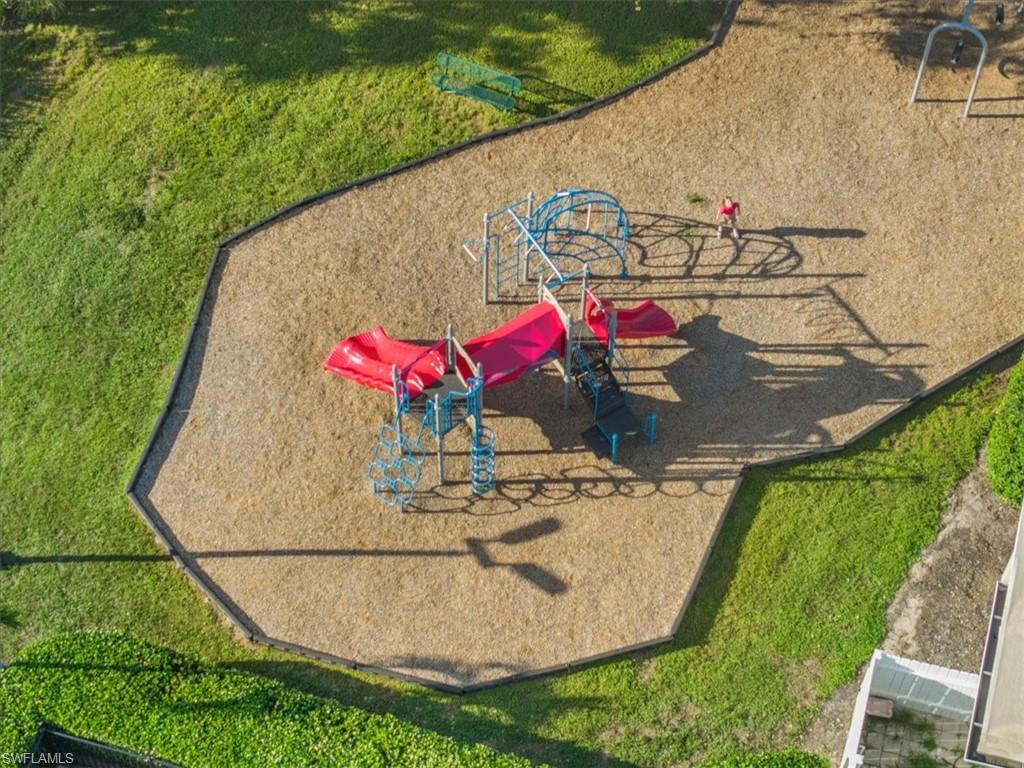 View of playground featuring a lawn