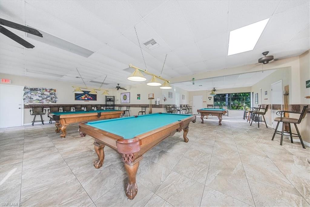 Recreation room featuring billiards table, ceiling fan, and a drop ceiling