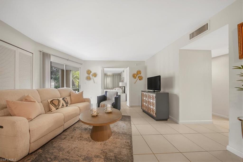 Living area with light tile patterned floors and baseboards