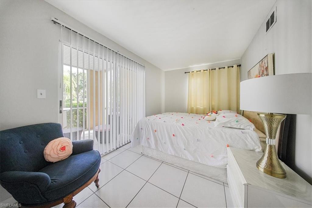 Bedroom featuring access to exterior and tile patterned flooring