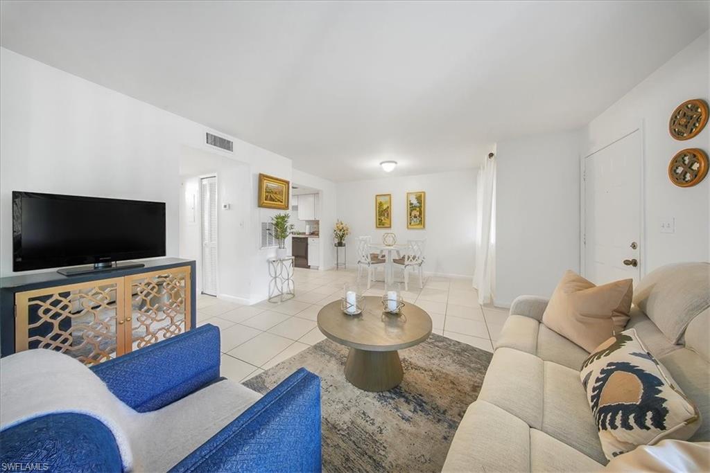 Living room with light tile patterned floors