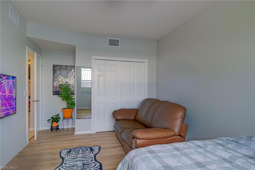 Bedroom featuring wood finished floors and a closet