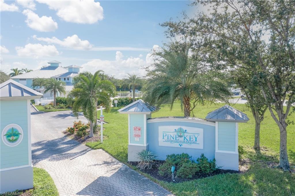View of community featuring a yard and decorative driveway
