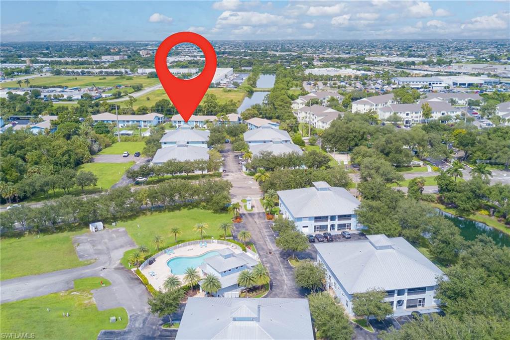 View of property location with a pool area and nearby suburban area