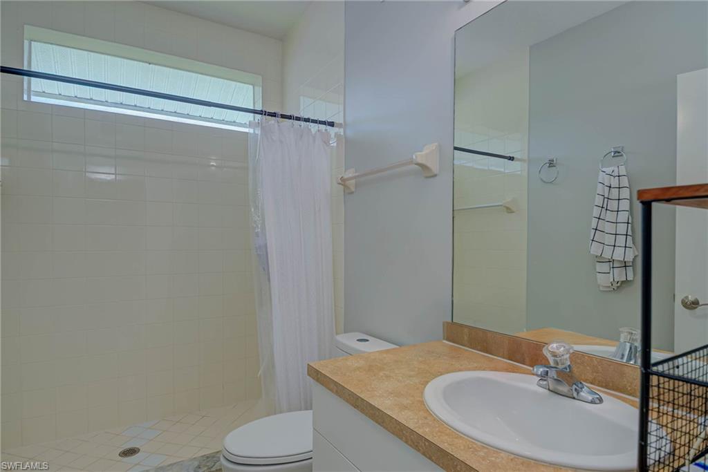 Bathroom featuring vanity and a stall shower
