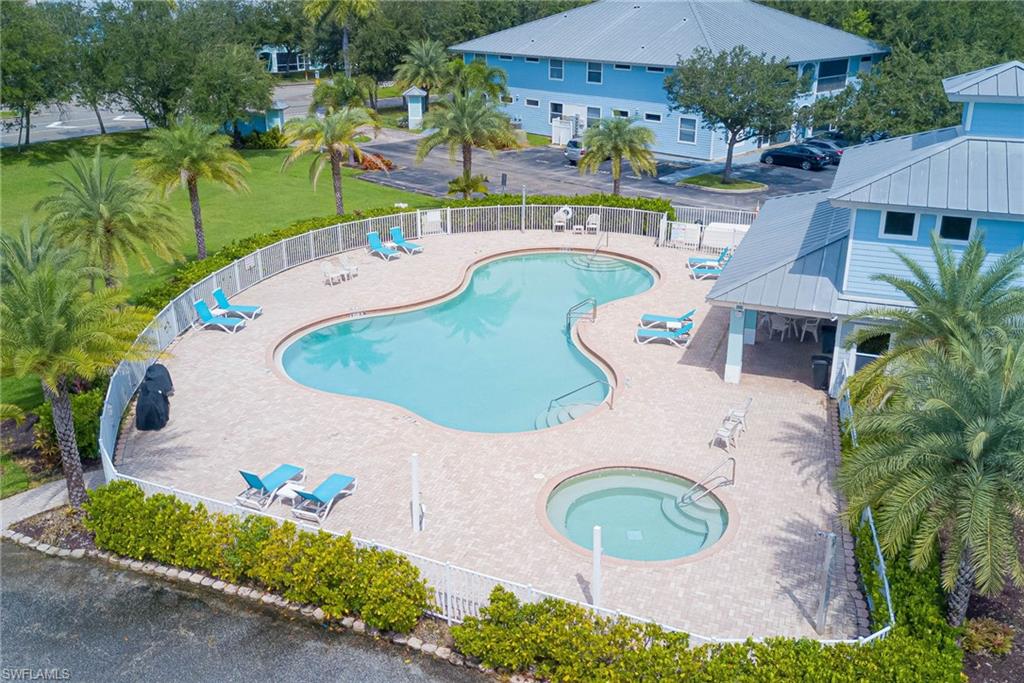 Community pool with a patio area and a community hot tub